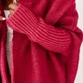 Detailed macro view showing the chunky fuchsia knit texture of this batwing sleeve cardigan - S / Tops / Red