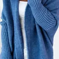 Close-up of blue knitted cardigan showing soft texture and batwing sleeve details. - S / Tops / Denim Blue