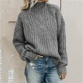 Detailed view showing the intricate grey cable-knit pattern of this women's turtleneck sweater. - S / Tops / Gray