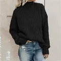 Detailed view of women's black high-neck cable-knit sweater with thick texture - S / Tops / Black