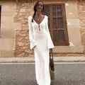 Full-length view of white knitted hollow-out beach dress on model in rustic outdoor setting - S / Top And Bottom / White