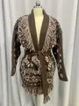 Detailed view of a brown knit cardigan featuring fringe trim and ethnic jacquard patterns - S / Tops / Dark Brown