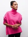 Détail d'un pull à col roulé rose surdimensionné avec une texture tricotée. - Rose rouge