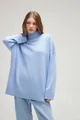Female model wearing an oversized light blue turtleneck knit sweater in a studio setting - Light Blue