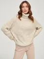 Detail view of a cozy beige oversized turtleneck chunky knit sweater for winter - Champagne