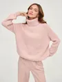 Close-up of a stylish pink turtleneck chunky knit sweater with visible ribbed texture for winter - S / Tops / Pink