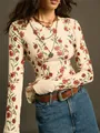 Detailed view of vintage red floral print on cream slim-fit knitted long sleeve top. - S / Tops / Apricot