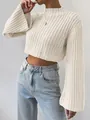 Detailed view of cream cropped sweater featuring wide flared sleeves and mock neck - S / Tops / Apricot