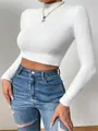 Detailed close-up view of a soft white fuzzy long sleeve cropped sweater with mock neck design - S / Tops / White