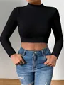 Front view of a slim fit black mock neck cropped sweater for women in soft fuzzy knit - S / Tops / Black
