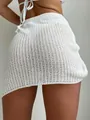 Detailed macro view showing the intricate white open-knit crochet texture of this beach skirt. - S / Bottoms / White