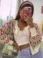 Close-up of a floral pattern knit cardigan with buttons in a lifestyle setting - S / Tops / Apricot Yellow