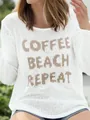 Detailed view of a white knitted sweater featuring the COFFEE BEACH REPEAT text - S / Tops / White