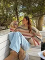 Woman wearing chunky retro striped sweater with batwing sleeves in an outdoor setting - S / Tops / Khaki