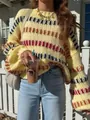 Close-up of retro chunky knit sweater with colorful stripes and wide batwing sleeves. - S / Tops / Yellow