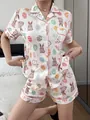 Detailed view of women's short-sleeve pajama set with Easter bunny and egg print. - S / Top And Bottom / White Easter Rabbit Print