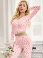 Detailed view of women's pink floral pajama set featuring elegant white lace trim accents - S / Top And Bottom / Pink