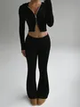 Full front view showing the fit of a black ribbed zip-up hoodie and flared pants - S / Top And Bottom / Black