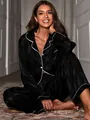 Elegant black satin striped 2-piece pajama set with white piping detail on model. - S / Top And Bottom / Black