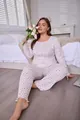 Full view of plus size women's floral pajama set with long sleeves and pants in a bedroom - 1XL / Top And Bottom / White