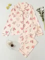 Flat lay detail of pink pajamas featuring cute heart print and contrast piping. - S / Top And Bottom / Light Pink