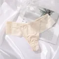 Macro detail view of beige seamless ice silk thong with elegant striped lace trim - Apricot