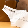 Premium white seamless women's thong with a stylish fishnet cutout waist design - M / Bottoms / White