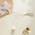 Elegant seamless cream thong with thin side straps for a minimalist fitness aesthetic - Nude/Beige