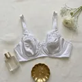 Elegant white lace and satin plus size underwire bra on a natural linen background - 85D / Tops / White