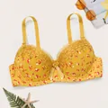 Vista detallada de sujetador push-up amarillo con flores, encaje bordado y lazo central. - Amarillo