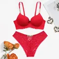 Detail view of red lace lingerie set with elegant rhinestone metal chain straps - Red