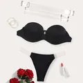 Detail view of black strapless bra set with detachable clear straps and matching thong. - 36/80B (Brief L) / Top And Bottom / Black