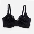 Detailed close-up view of the black floral lace and center bow on the underwire bra - 36/80C / Tops / Black