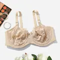 Close-up of elegant beige lace bra detailing intricate floral patterns and supportive underwire - Off White
