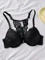 Close-up detail of a black lace front-closure bra with an intricate floral racerback design - 70B / Tops / Black