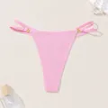 Detailed view of a pink ribbed thong bikini bottom with thin side straps and gold rings - M / Bottoms / Light Pink