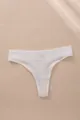 White ribbed thong featuring a low-waist design and breathable solid cotton fabric. - White