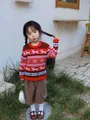 Little girl wearing red festive reindeer snowflake knit Christmas sweater outdoors - Red (Kids')