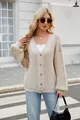 Outdoor shot of a stylish woman wearing a beige V-neck cable knit cardigan sweater. - S / Tops / Off White