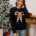 Elegant women's black Christmas knit sweater featuring sequined candy cane and golden bow - S / Tops / Black
