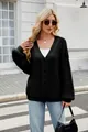 Close-up detail of a stylish black oversized cable-knit cardigan worn by a model outdoors - S / Tops / Black