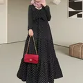 Elegant black and white polka dot long sleeve maxi dress featuring a tiered skirt and waist tie - S / Top And Bottom / Black
