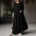 Full-length view of a minimalist black cotton linen maxi dress with long sleeves on a model. - S / Top And Bottom / Black