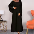 Close-up full view of black modest maxi dress with wide sleeves shown in a modern interior setting - S / Top And Bottom / Black
