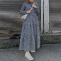 Detailed shot of a blue gingham tiered maxi dress with long puff sleeves and tiered skirt. - S / Top And Bottom / Dark Blue