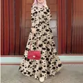 Full-length view of a beige floral print long dress with a matching waist belt - S / Off White