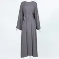 Front view of a minimalist solid grey long-sleeved midi dress with matching waist belt - Gray