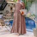 Floral tiered maxi dress with front buttons shown in an outdoor poolside resort setting - S / Top And Bottom / Burgundy