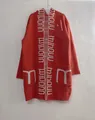 Detailed view of the orange long hooded cardigan featuring white letter knit patterns - S / Tops / Orange