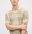 Close-up detail of a beige knit Polo shirt featuring a striped pointelle pattern and V-neck - M / Tops / Apricot